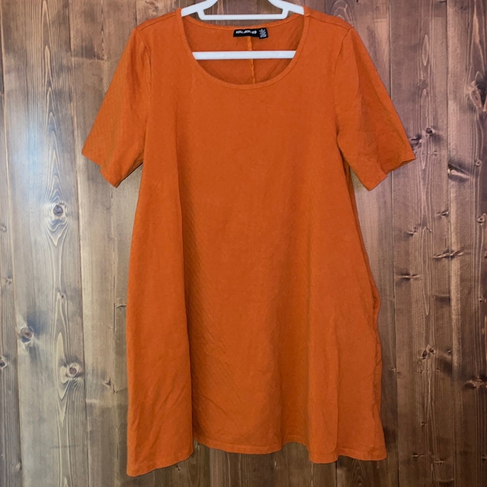 Burnt orange dress, cute pattern. Rounded neck. Never worn.